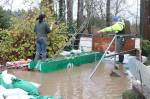 Ruby Randolph, 16, helps her dad Steve Randolph, a board member for Sustainable Renton, build up another wall of sandbags late Dec. 11 as water from the Cedar River seeps into the backyard of a Maplewood resident. Photo by Bailey Jo Josie/Sound Publishing