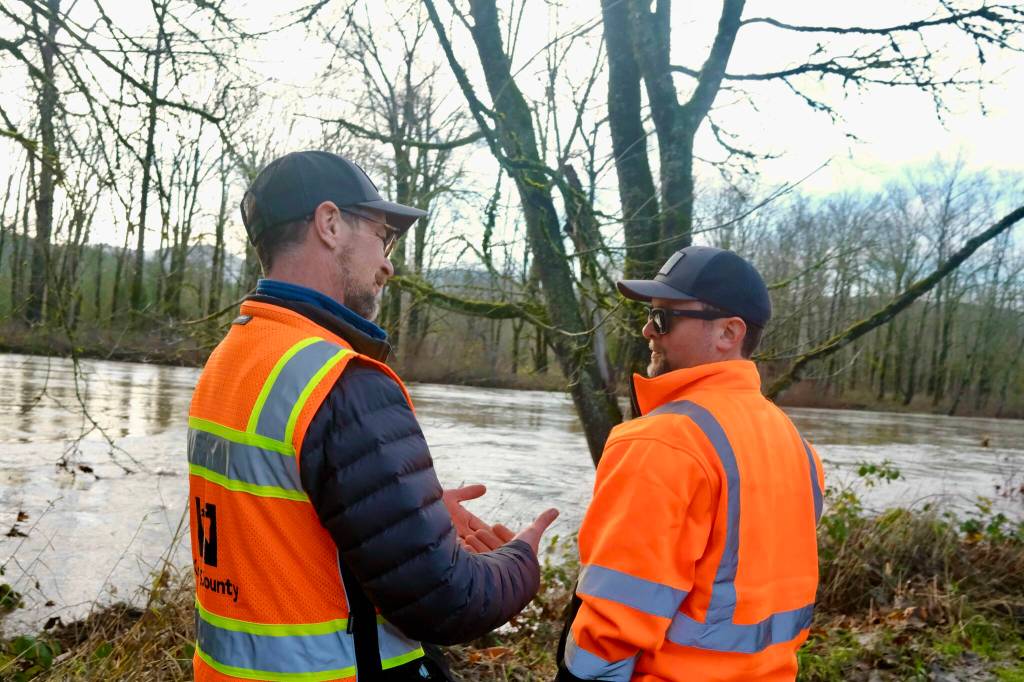 King County Flood Patrol members Thomas Bannister (left) and Seth Ballhorn on their patrol route, Dec. 9, 2025. (Grace Gorenflo/Sound Publishing)