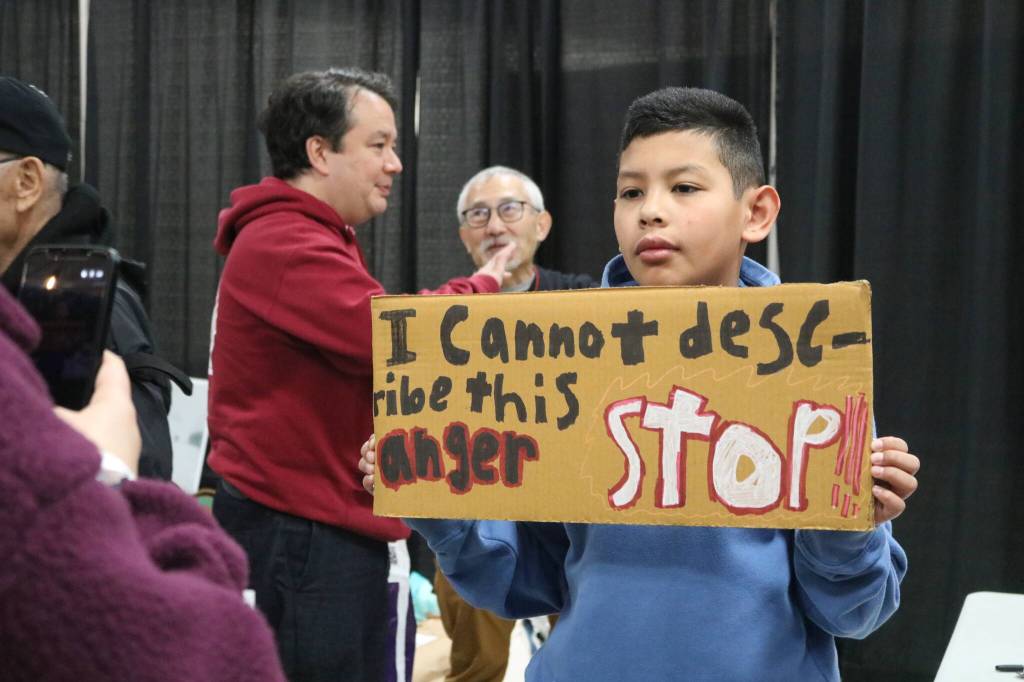 Community members make signs at the Tsuru for Solidarity station.