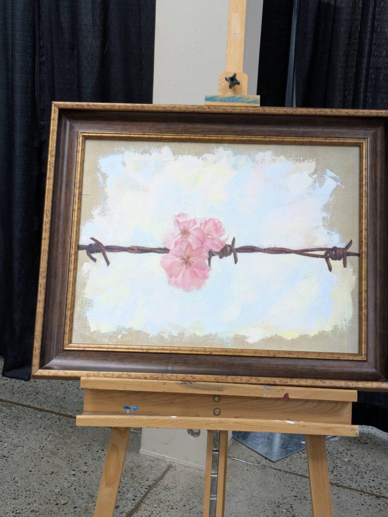 Cherry blossoms and barbed wire express a reflection on Japanese incarceration in this painting by Chris Hopkins. Photo by Bailey Jo Josie/Sound Publishing