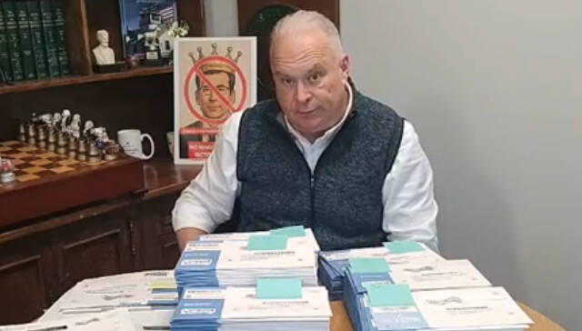 A screenshot from the video Washington State Republican Party Chair Jim Walsh posted with ballots he says were handed off to him by a concerned citizen who found them next to a dumpster in Renton. (Video screenshot via Facebook)