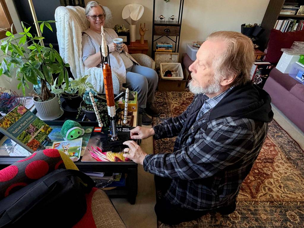 Hussey showing a recently released Lego model of Artemis II, with his wife Terrie Landers in the background. Photo by Joshua Solorzano/The Mirror.
