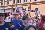 Fans hoist scarves as the march to Seattle Stadium continued. Ben Ray / The Reporter
