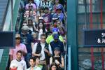 Fans pack the stairs heading to the light rail train at International District. Ben Ray / The Reporter