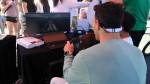 Summer Celebration attendees engage in a hydroplane racing simulator. Andy Nystrom/ staff photo